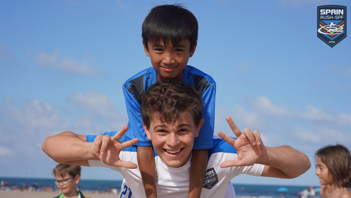 Two players smiling at the beach