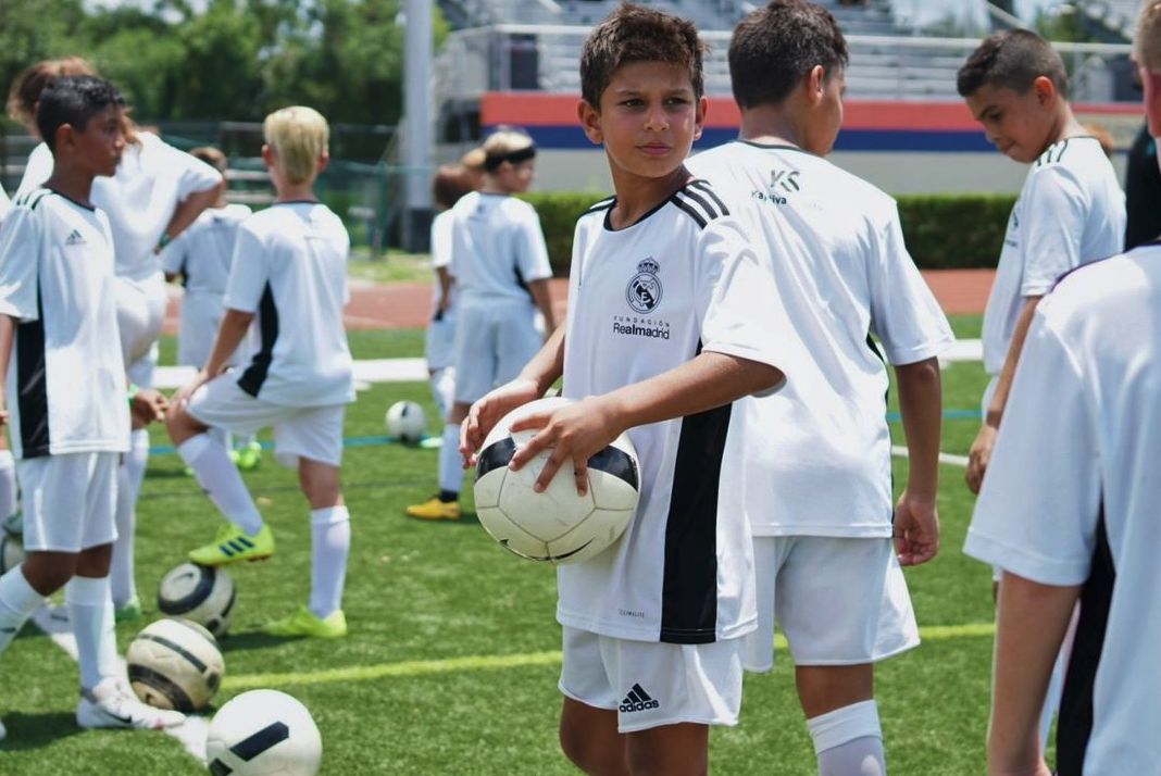 Young players training on a pitch in Madrid
