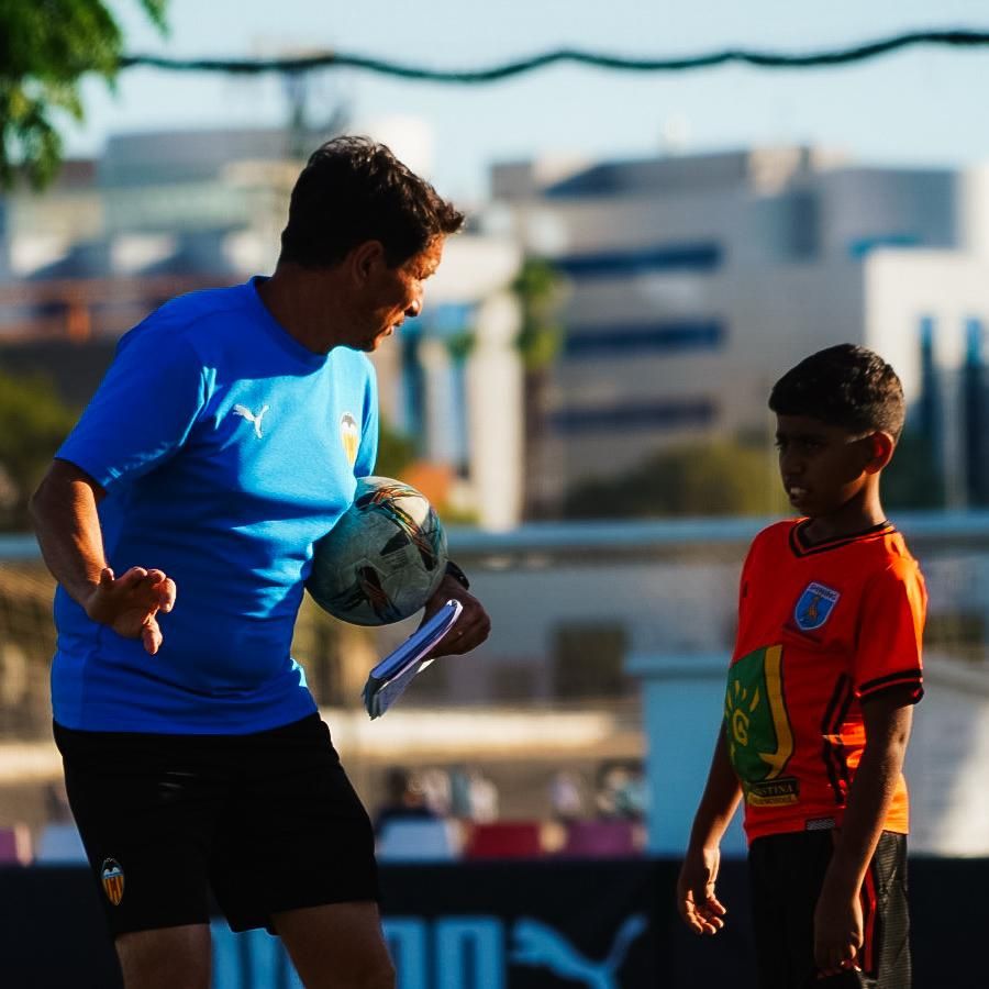 A coach and a young player at a training session in Valencia
